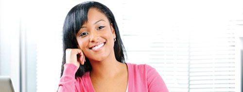 A smiling female student thining about a topic for her research paper